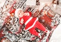 Baby first Christmas. New Year`s holidays. Baby with santa hat with gift. Royalty Free Stock Photo