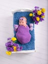 Baby and flower, newborn sleep in the bed, girl photo Royalty Free Stock Photo