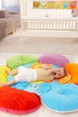 Baby on flowery playmat