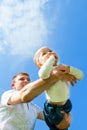 Baby flying on father's hands Royalty Free Stock Photo