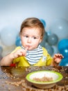 Baby food, babies eating. Funny kid boy with plate and spoon. Royalty Free Stock Photo