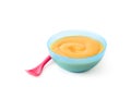 Baby food: blue bowl with fruit puree isolated