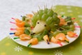 Baby food in the form of a hedgehog from grapes. Children`s menu on a green background.