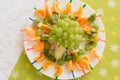 baby food in the form of a hedgehog from grapes. Children's menu on a green background.