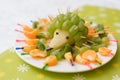 baby food in the form of a hedgehog from grapes. Children's menu on a green background.