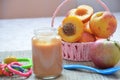 Baby food, baby fruit mashed in a glass jar, peach, beautiful peaches in a basket, children`s toy. apple Royalty Free Stock Photo