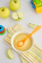 Baby food. Homemade apple puree or sauce from organic apples in a bowl with a spoon on a light background with fresh apples. Royalty Free Stock Photo