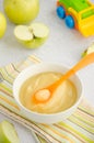 Baby food. Homemade apple puree or sauce from organic apples in a bowl with a spoon on a light background with fresh apples. Royalty Free Stock Photo