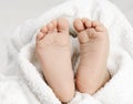 Baby foot close up with white towel Royalty Free Stock Photo