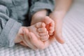 Baby foot in mom`s hands. The feet of a tiny newborn baby on a female hand shape close up Royalty Free Stock Photo