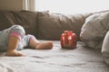 Baby foot and red toy on the bed Royalty Free Stock Photo