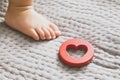 Baby foot and red toy on the bed Royalty Free Stock Photo