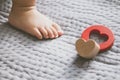 Baby foot and red toy on the bed Royalty Free Stock Photo