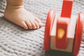 Baby foot and red toy on the bed Royalty Free Stock Photo