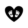 Baby footprints with pet pawprints inside of black heart Royalty Free Stock Photo