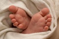 Baby foots in bedsheet