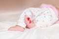 Baby foots with hearts on their feet. A newborn baby is lying on