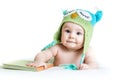 Baby in funny knitted hat owl with book Royalty Free Stock Photo