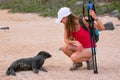 Baby Galapagos sea lion looking at young woman on North Seymour Royalty Free Stock Photo
