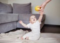 Baby gets an apple from mother. Mother gives to daughter her first food Royalty Free Stock Photo