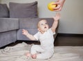 Baby gets an apple from mother. Mother gives to daughter her first food Royalty Free Stock Photo