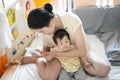 Baby getting fingernails,Mother file baby nail by electric nail file,nursing a child at home.Children care concept.