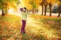 Baby girl in autumn leaves in the Park in the fresh air.girl playing with a small dog outdoors in autumn.