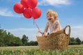 Baby Girl in a Basket with Red Balloons