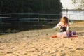 Baby girl beach playing alone sand spring clothes Royalty Free Stock Photo