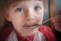 Baby girl being fed by hand. Royalty Free Stock Photo