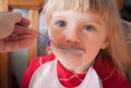 Baby girl being fed by hand. Royalty Free Stock Photo