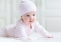 Baby girl with big blue eyes on white blanket Royalty Free Stock Photo