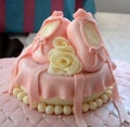 Baby girl birthday cake with cute baby shoes