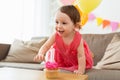 Baby girl with birthday cupcake at home party Royalty Free Stock Photo