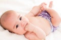 Baby girl biting her hand wearing ecologic cloth diaper Royalty Free Stock Photo