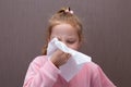 Baby girl blowing her nose in a napkin Royalty Free Stock Photo