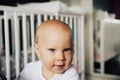 Baby girl with blue eyes and blond hair is smiling Royalty Free Stock Photo