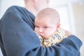 Baby Girl with Bored Expression in the Arms of Her Granddad