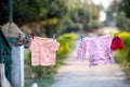 Baby Girl and boy clothes drying on a rope. Shoes hanging on ropes Royalty Free Stock Photo