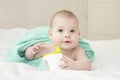 Baby girl boy wrapped in a towel holding a non-spill cup. Caucasian baby portrait soft focus Royalty Free Stock Photo