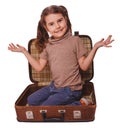 Baby girl brunette sitting in a suitcase for travel isolated on Royalty Free Stock Photo