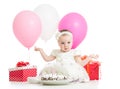 Baby girl with cake, balloons and gifts