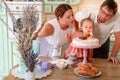 Baby girl with a cake in kitchen at home. family home two years birthday. Royalty Free Stock Photo