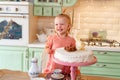 Baby girl with a cake in kitchen at home. family home two years birthday. Royalty Free Stock Photo