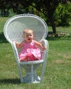 Baby girl on chair in park Royalty Free Stock Photo