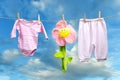 Baby girl clothes with flower on the clothesline