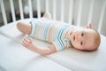 Baby girl in co-sleeper crib Royalty Free Stock Photo