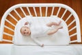 Baby girl in co-sleeper crib Royalty Free Stock Photo