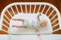 Baby girl in co-sleeper crib Royalty Free Stock Photo