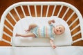 Baby girl in co-sleeper crib Royalty Free Stock Photo